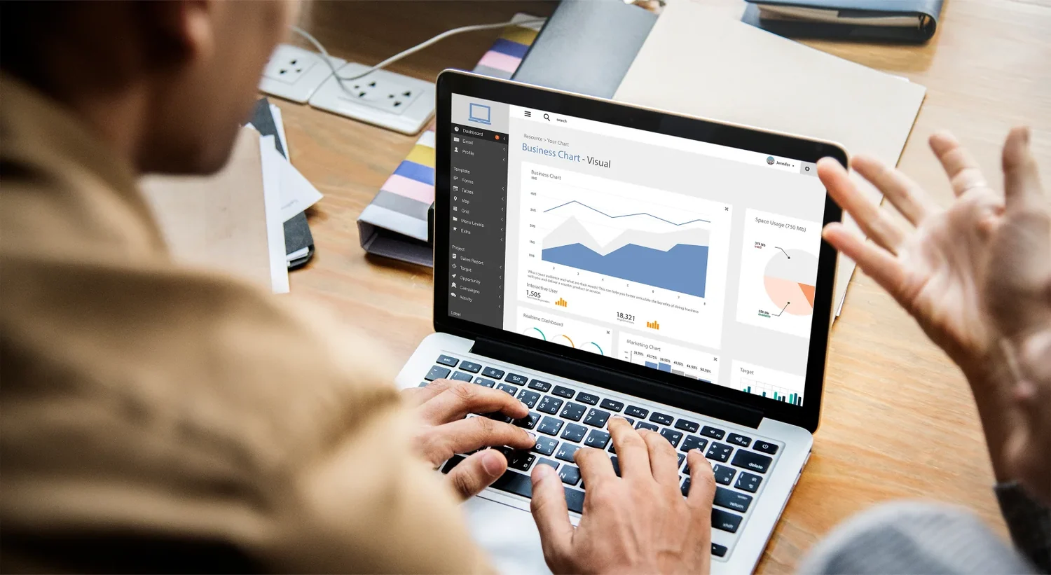 Two people reviewing performance charts on a laptop