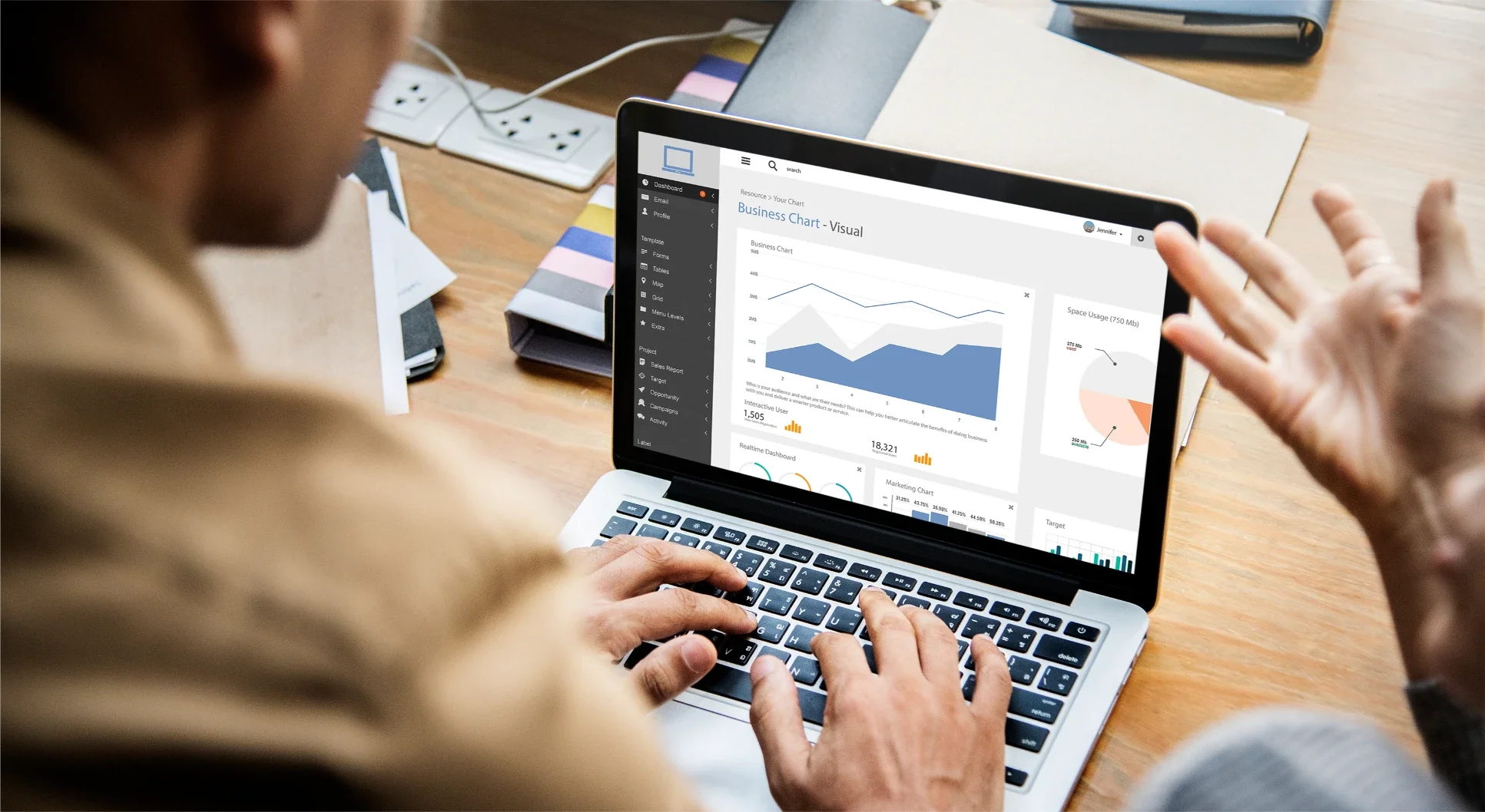 Hands on a laptop keyboard with a reporting dashboard on screen